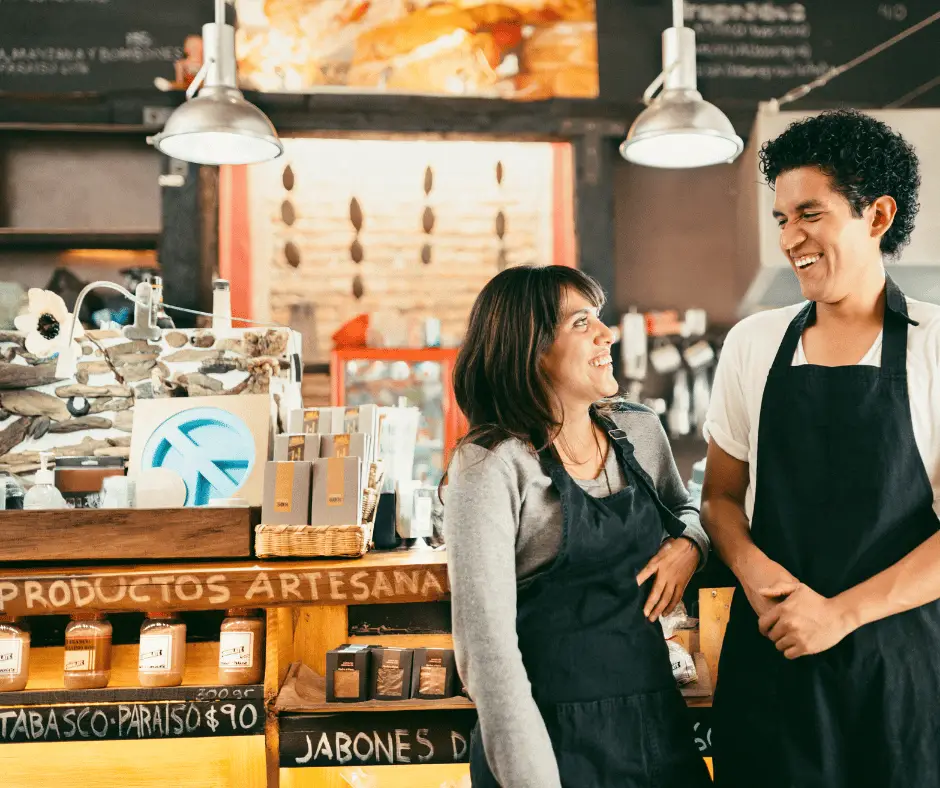 Two shop owners chatting in their store